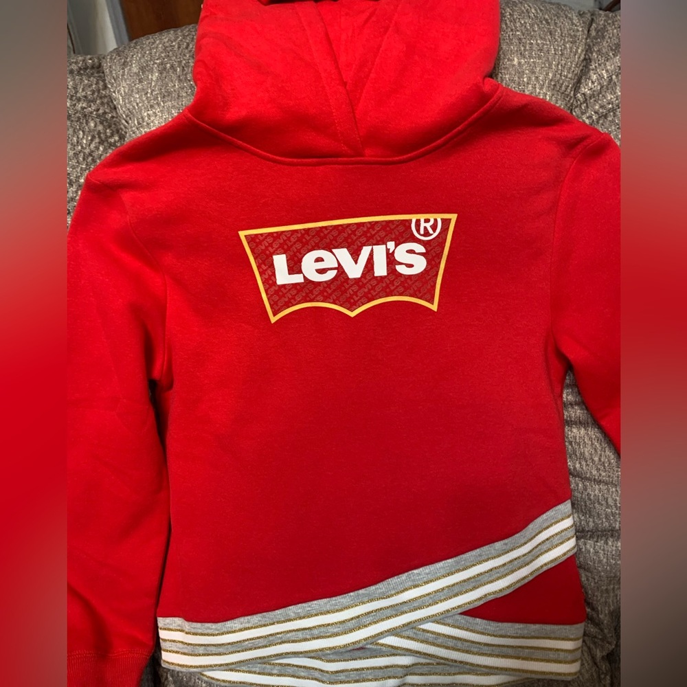 Levi’s Sweat shirt Red. Has stripped band around waistband. Has hood